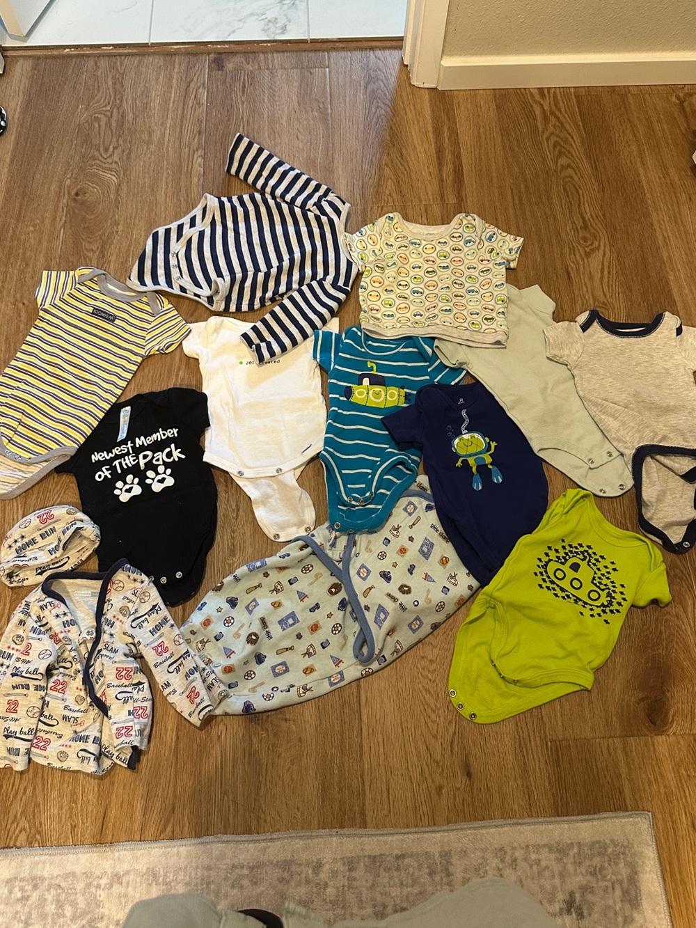 Lot of 13 baby boy newborn/3M items — onesies, tops, hat, and swaddle